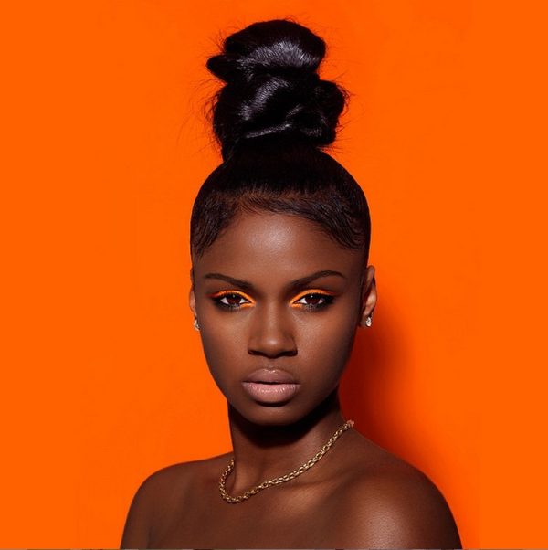 beautiful black woman with orange background